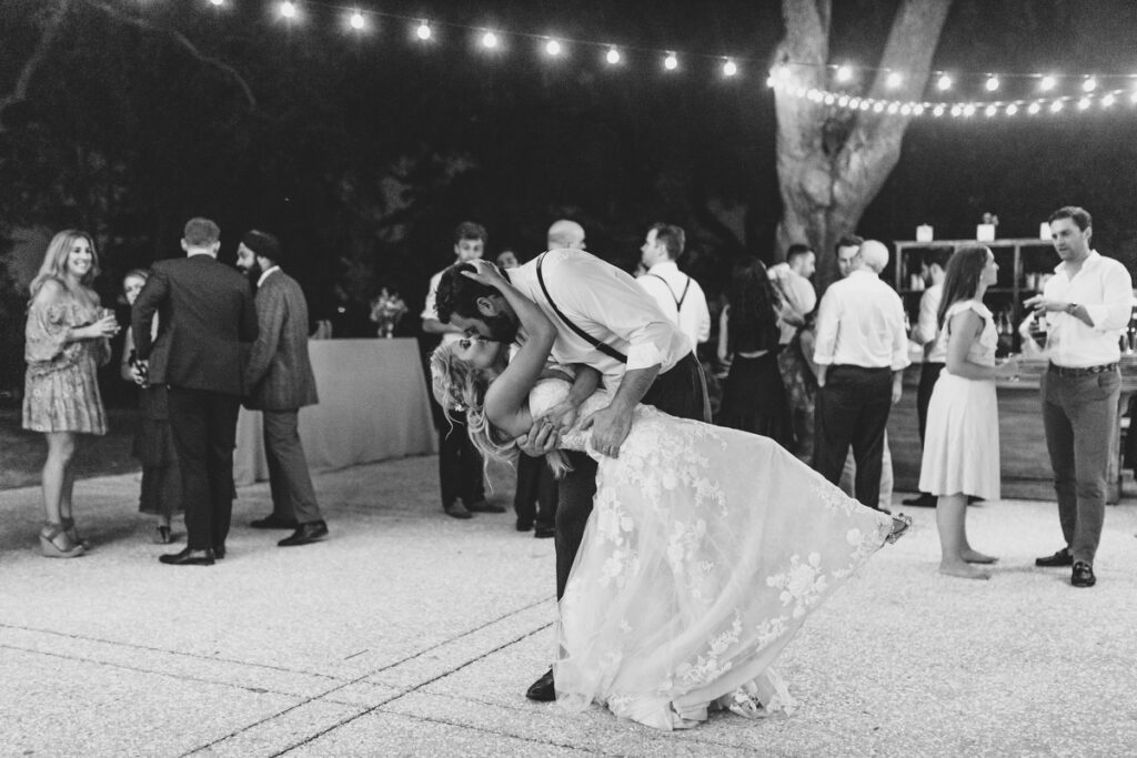 Lowndes Grove wedding bride and groom kiss under cafe lights