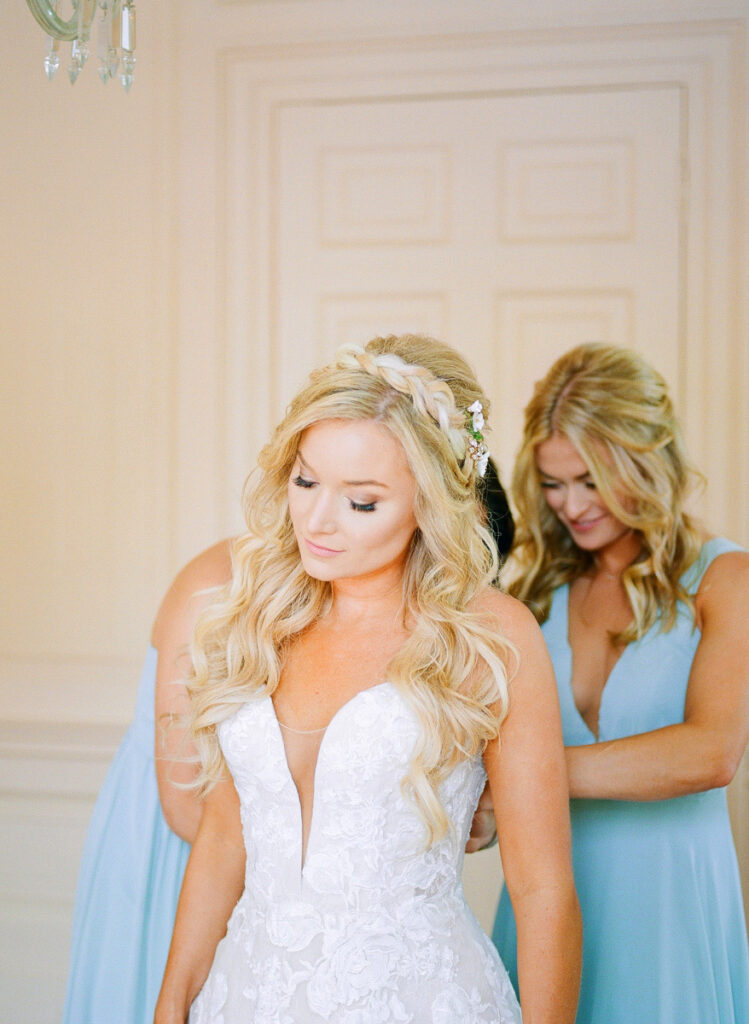 Lowndes Grove wedding bridesmaids helping bride get into her wedding dress