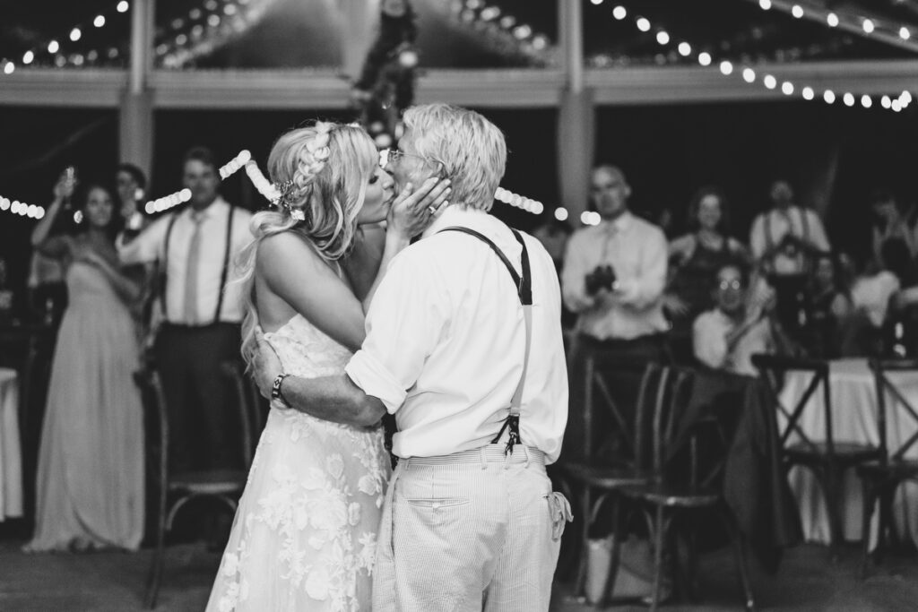 Lowndes Grove wedding bride kissing father's cheek after dance