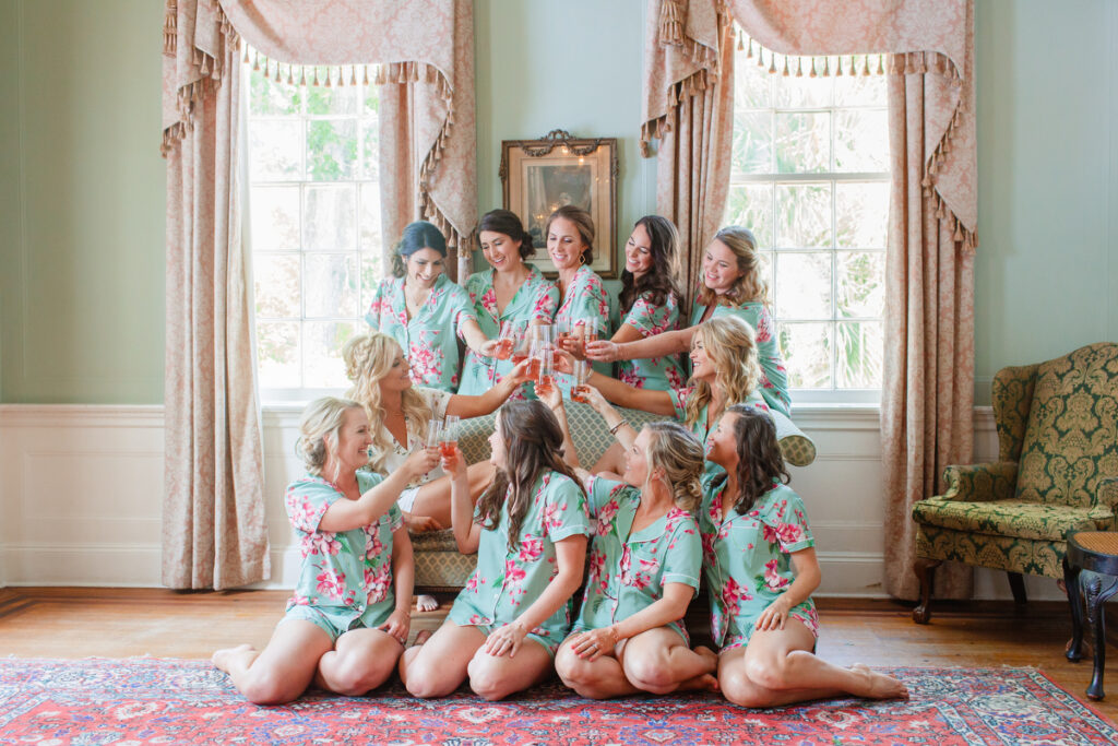 Lowndes Grove wedding bride and bridesmaids in pajamas toasting