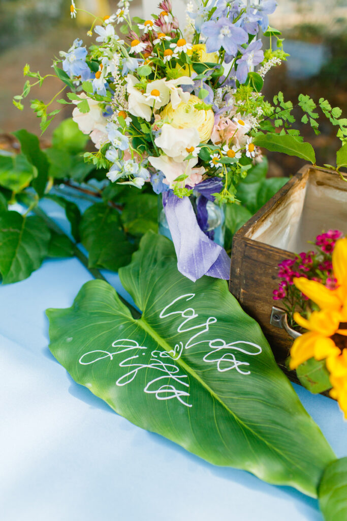 Lowndes Grove wedding reception decor cards and gift signage on palm leaf