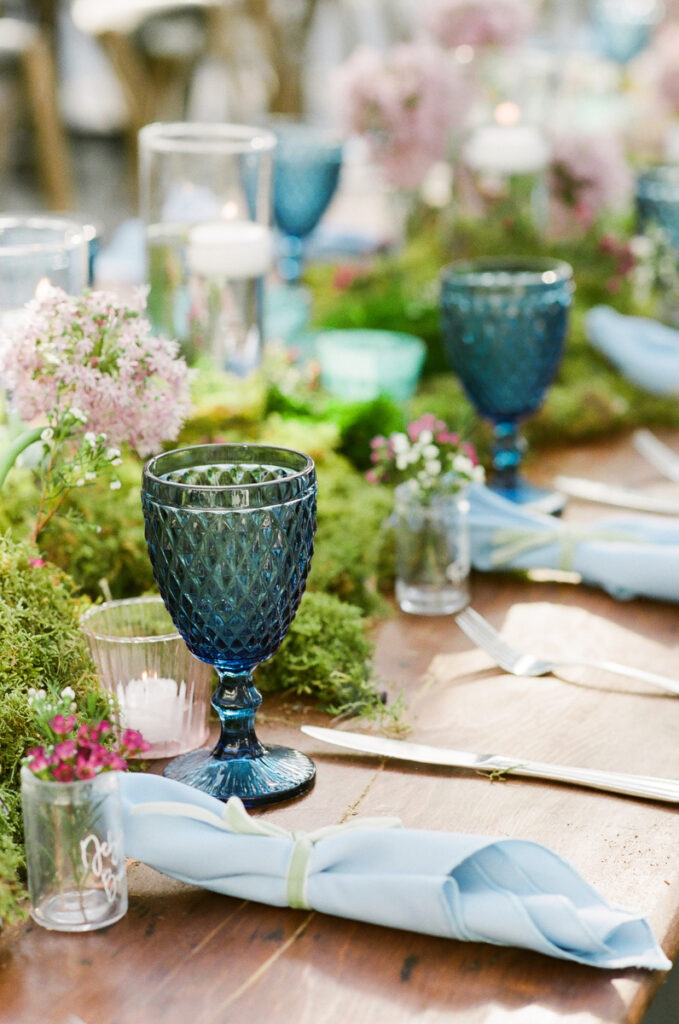 Lowndes Grove wedding reception table with green moss and blue goblets