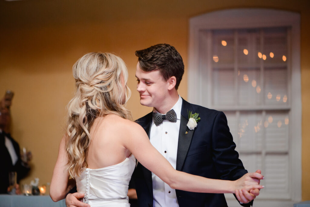 William Aiken House Wedding groom looks at bride during first dance