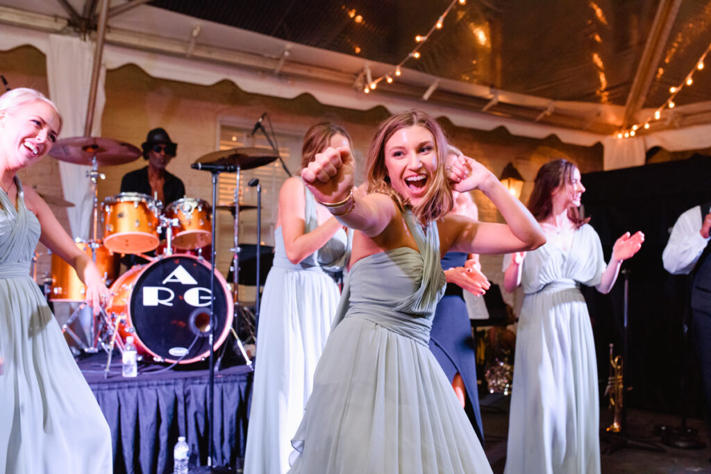 William Aiken House Wedding bridesmaids dancing on stage