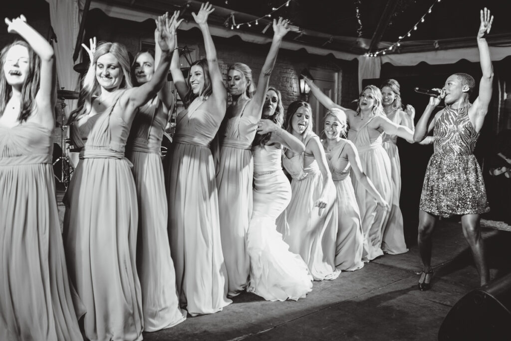 William Aiken House Wedding bride and bridesmaids dancing on stage