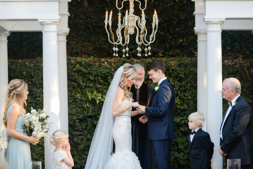 William Aiken House Wedding bride places wedding ring on groom's hand