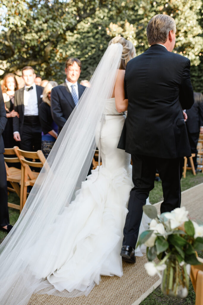 William Aiken House Wedding back of bride's dress walking down the aisle