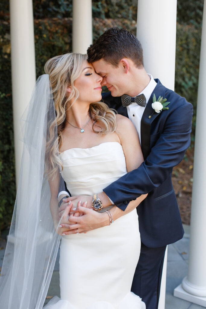 William Aiken House Wedding bride and groom hold each other under pergola