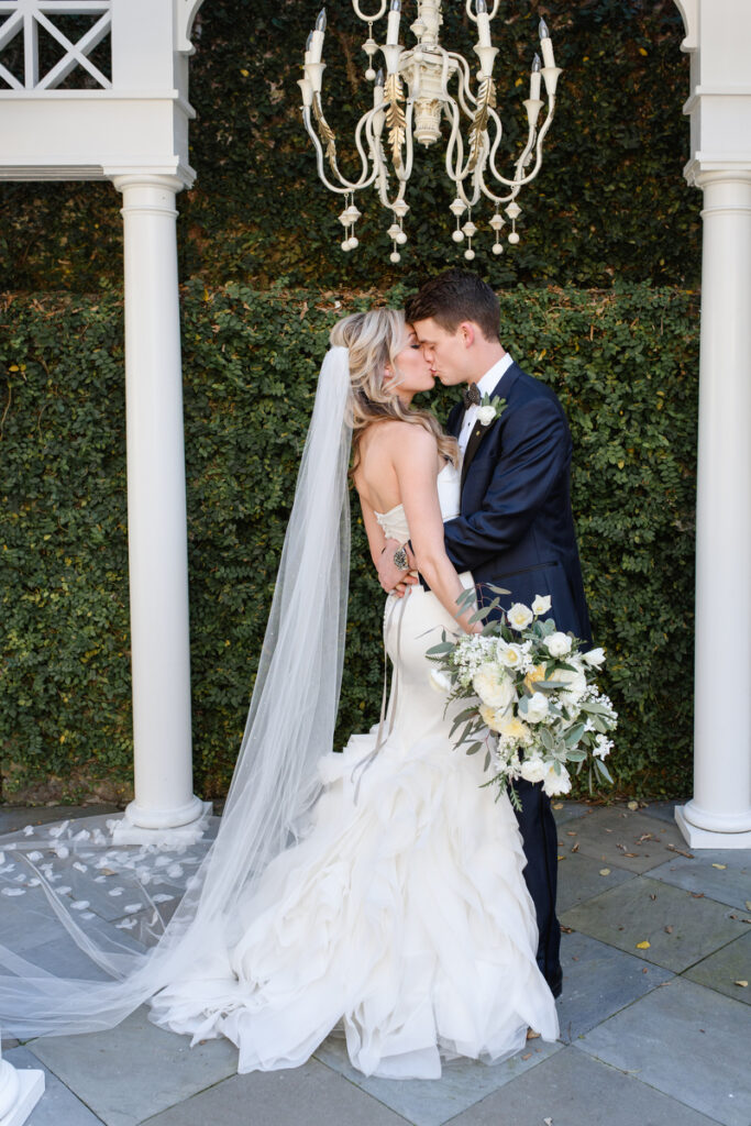 William Aiken House Wedding bride and groom kiss under pergola