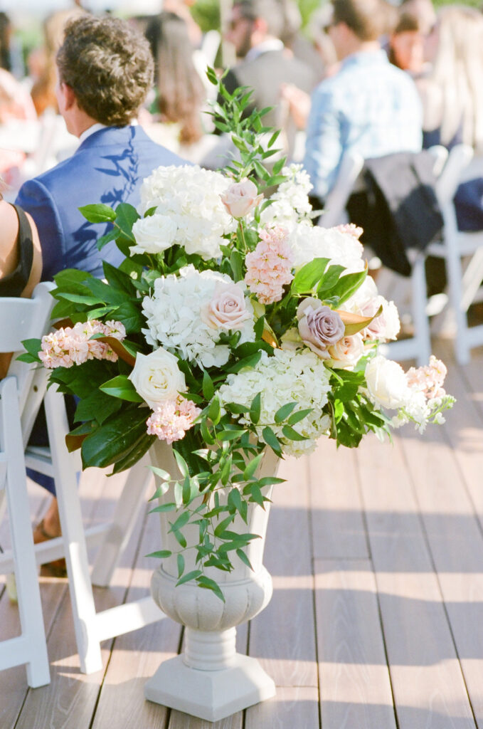 Westin Hilton Head wedding floral sprays in Tuscan-style planters at ceremony. White, pink, and mauve roses and white hydrangea flowers