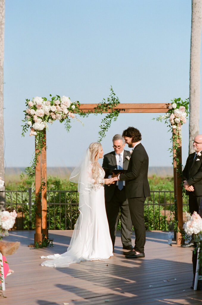 Westin Hilton Head wedding bride putting ring on groom's finger