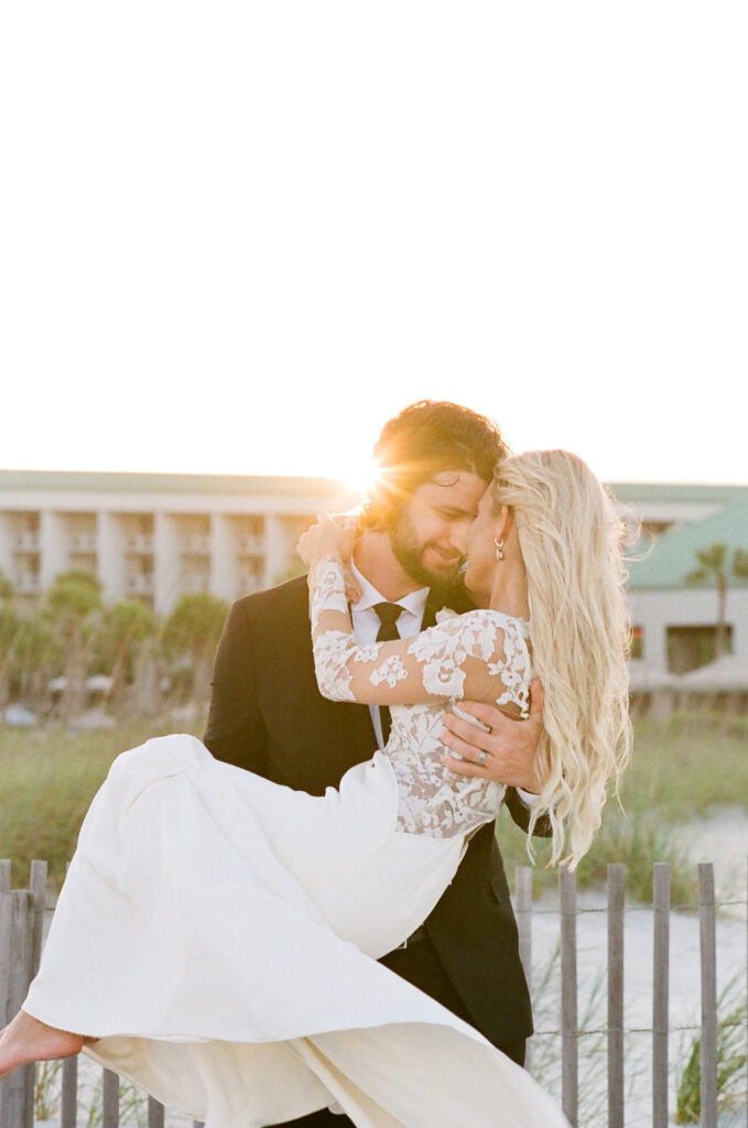 Westin Hilton Head wedding groom holding bride in his arms during sunset