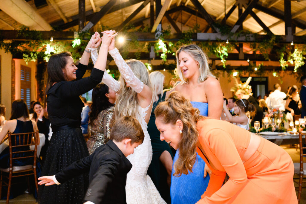 Bride and guests on the dance floor during the reception in the Trolley Room at a Cannon Green Wedding