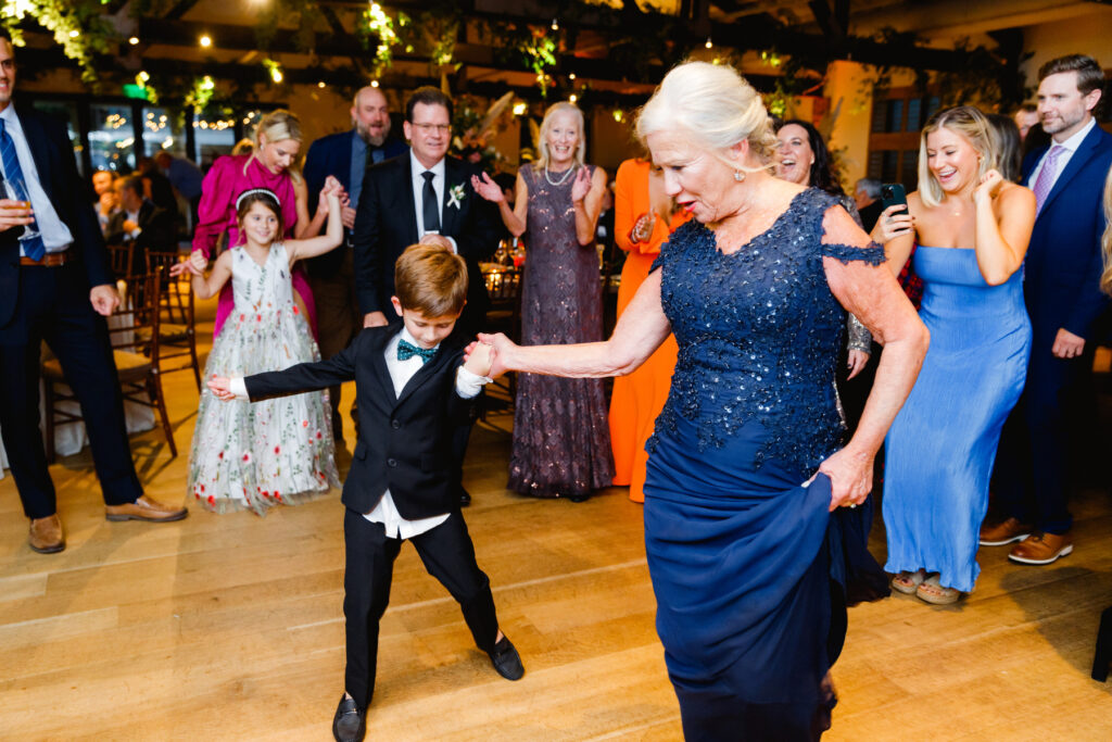 Mother of the bride dances with grandson during the reception in the Trolley Room at a Cannon Green Wedding