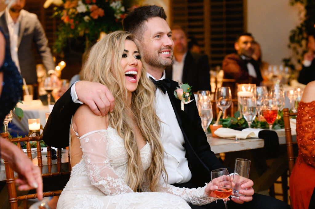 Bride's and groom's reactions to sisters of the bride giving a toast during the reception in the Trolley Room at a Cannon Green Wedding