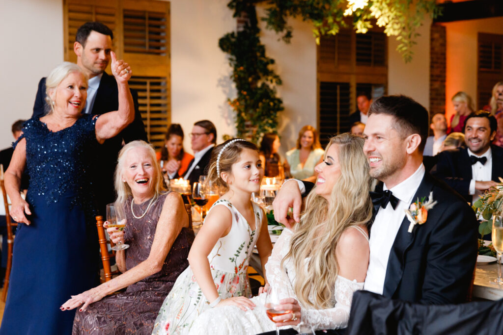 Guests and couple laughing at toasts during the reception in the Trolley Room at a Cannon Green Wedding