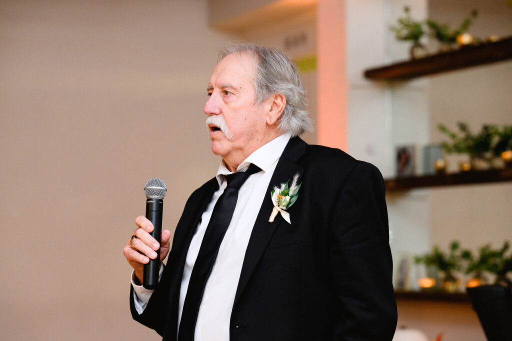 Father of the bride gives a toast during the reception in the Trolley Room at a Cannon Green Wedding