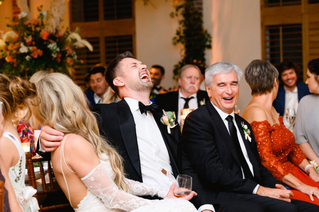 Groom laughing during the reception in the Trolley Room at a Cannon Green Wedding