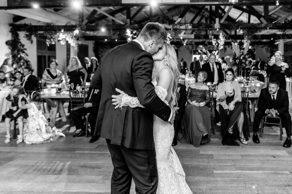 Bride and groom kiss on the dance floor during the reception in the Trolley Room at a Cannon Green Wedding