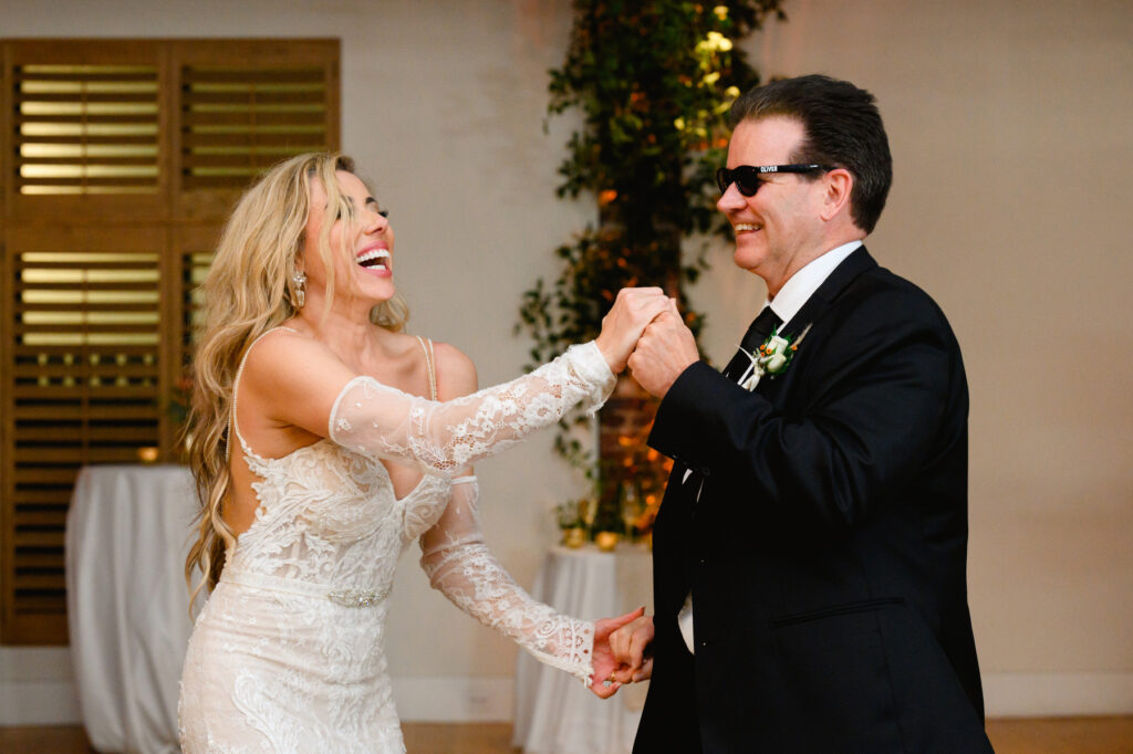 Bride dances with step father during the reception in the Trolley Room at a Cannon Green Wedding