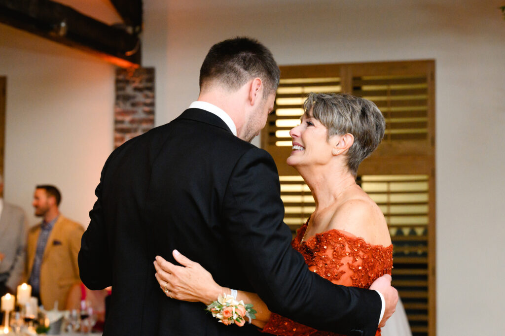 groom dances with his mother during the reception in the Trolley Room at a Cannon Green Wedding