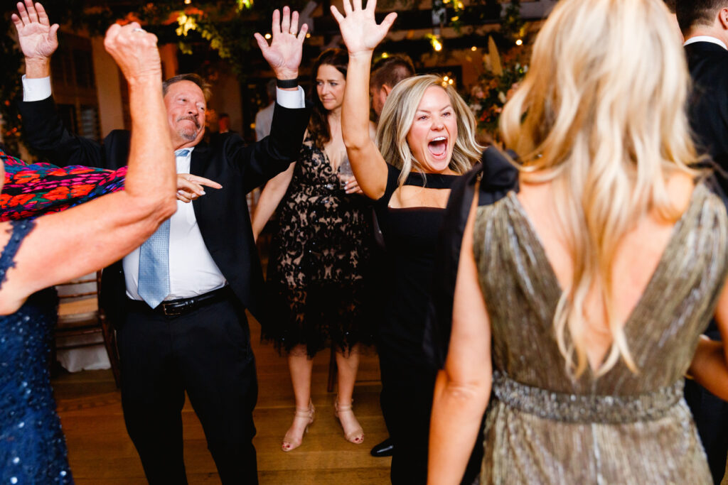 Guests dancing to the song "Shout" during the reception in the Trolley Room at a Cannon Green Wedding