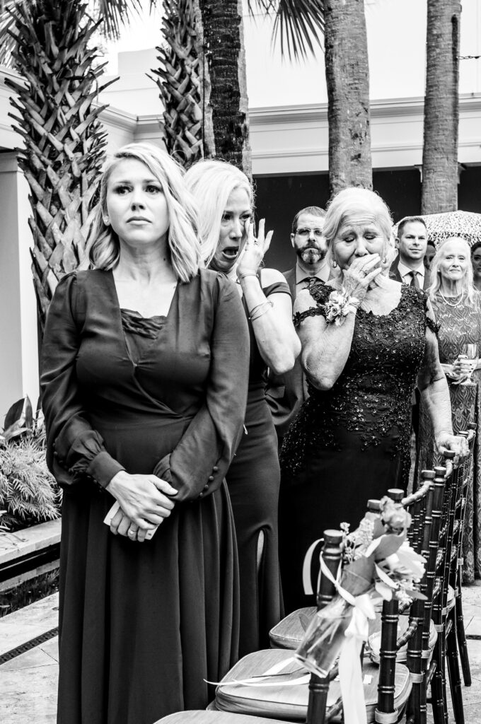 Sisters and mother of the bride begin to cry as bride walks down the aisle at a Cannon Green Wedding