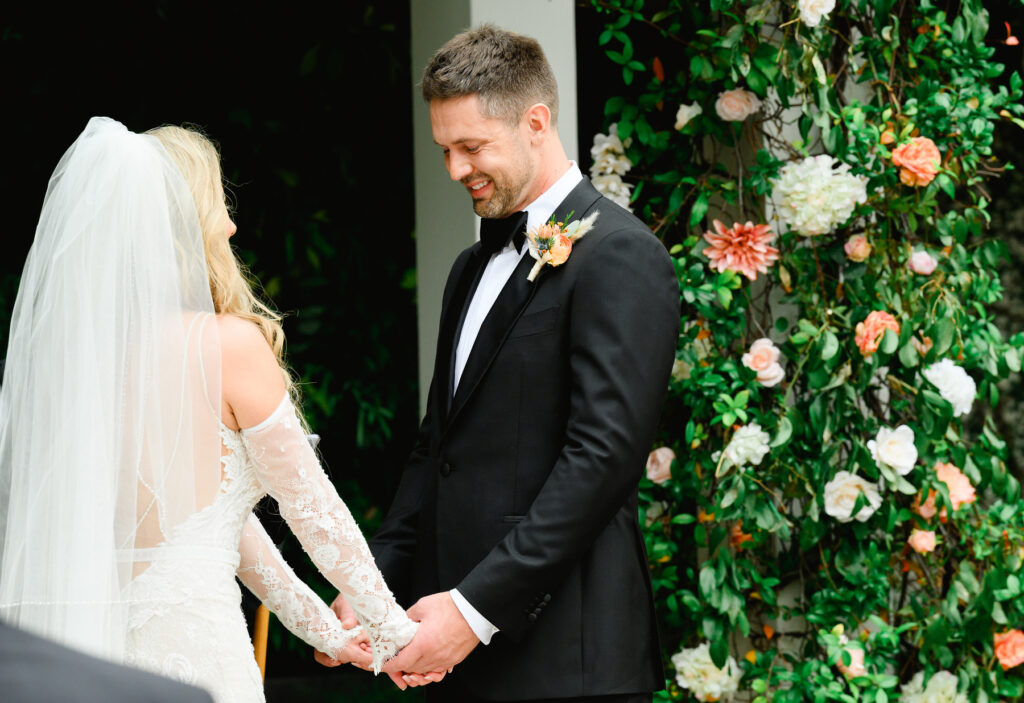 Groom smiles as couple prayer during a Cannon Green Wedding