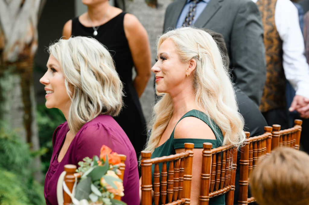 Bride's sisters smiling during ceremony at a Cannon Green Wedding