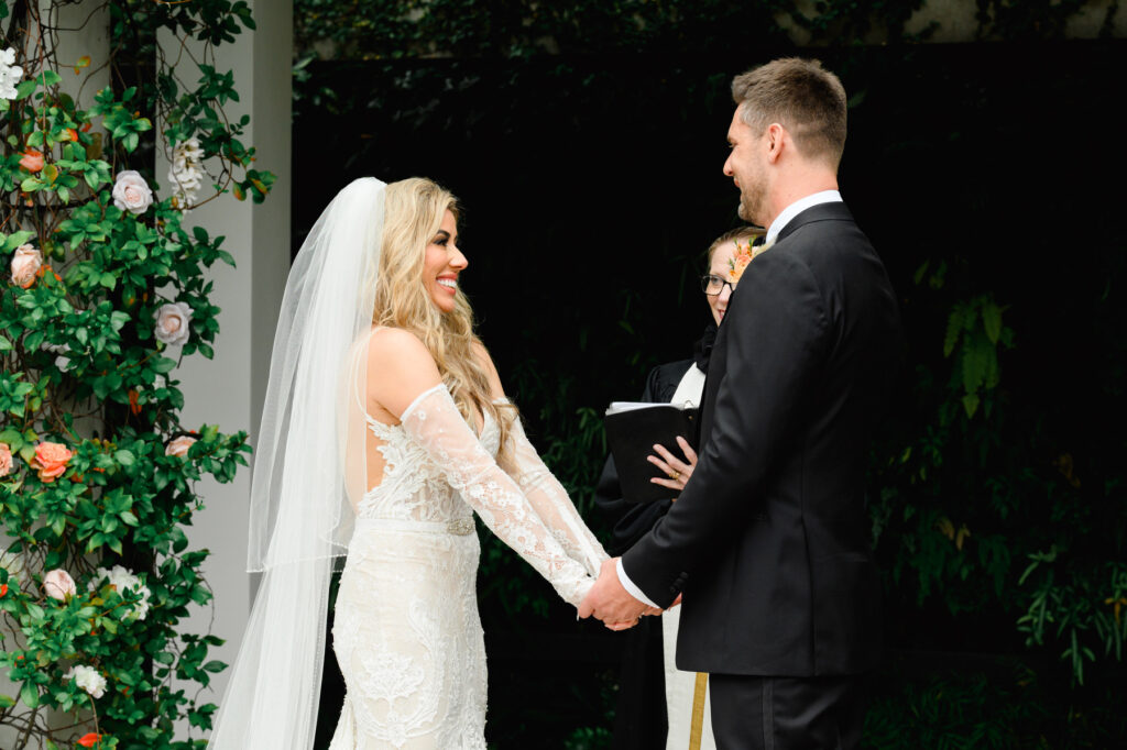 Bride smiles at groom during ceremony at a Cannon Green Wedding