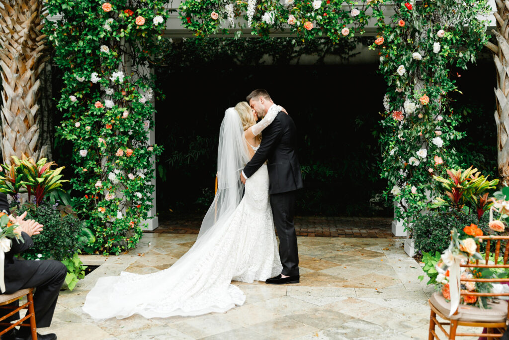 Bride and groom kiss in the courtyard at a Cannon Green Wedding