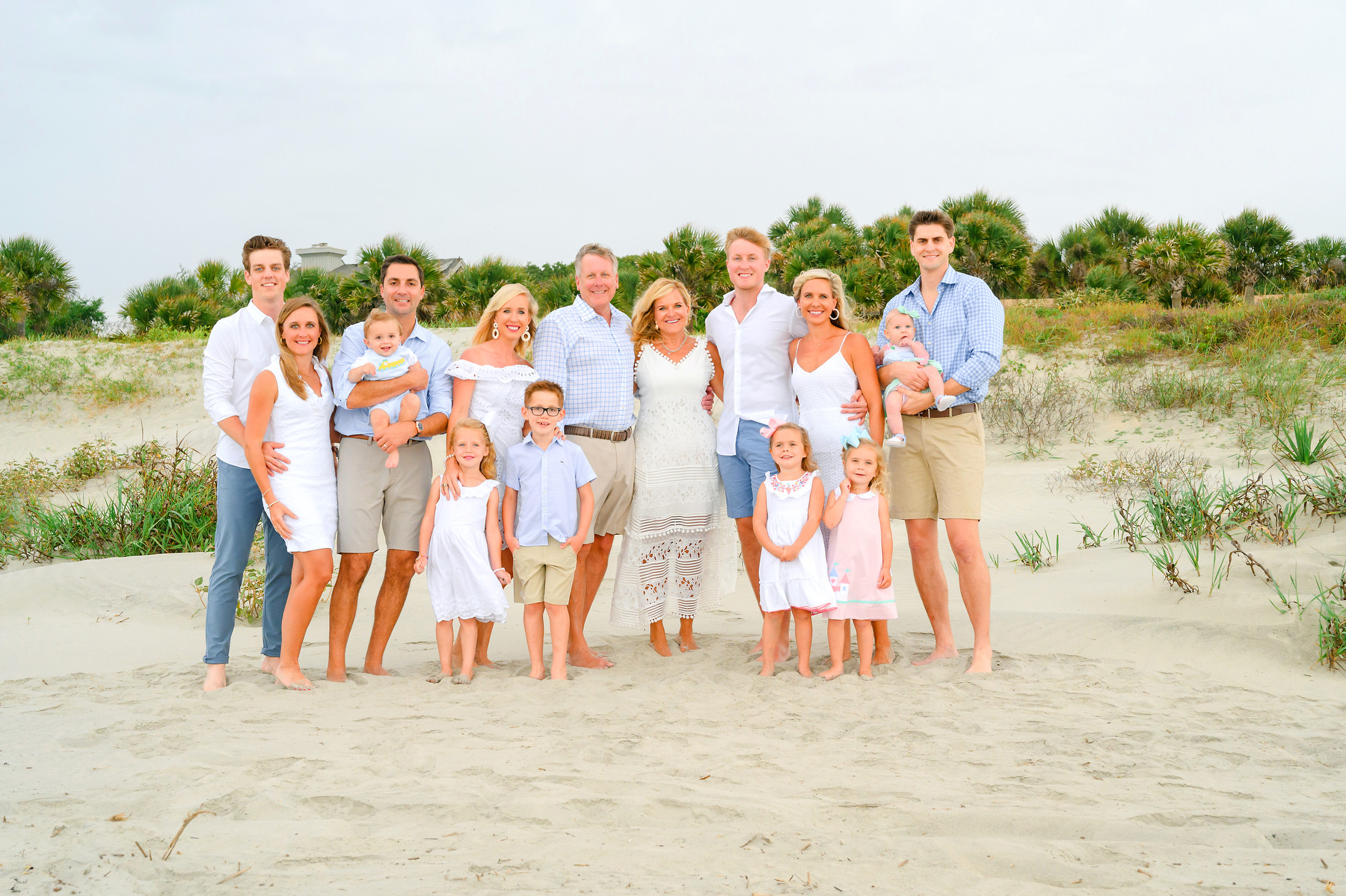 Multi-generational family pose near sand dunes during a Kiawah beach family photo