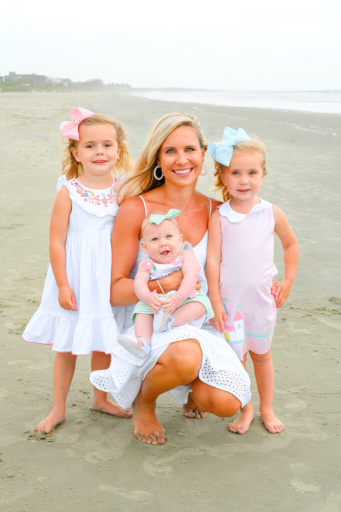 Mother poses with her three young daughters during a Kiawah beach family photo