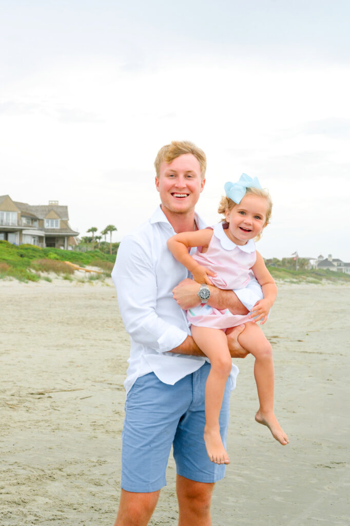 Uncle holds his niece during a Kiawah beach family photo