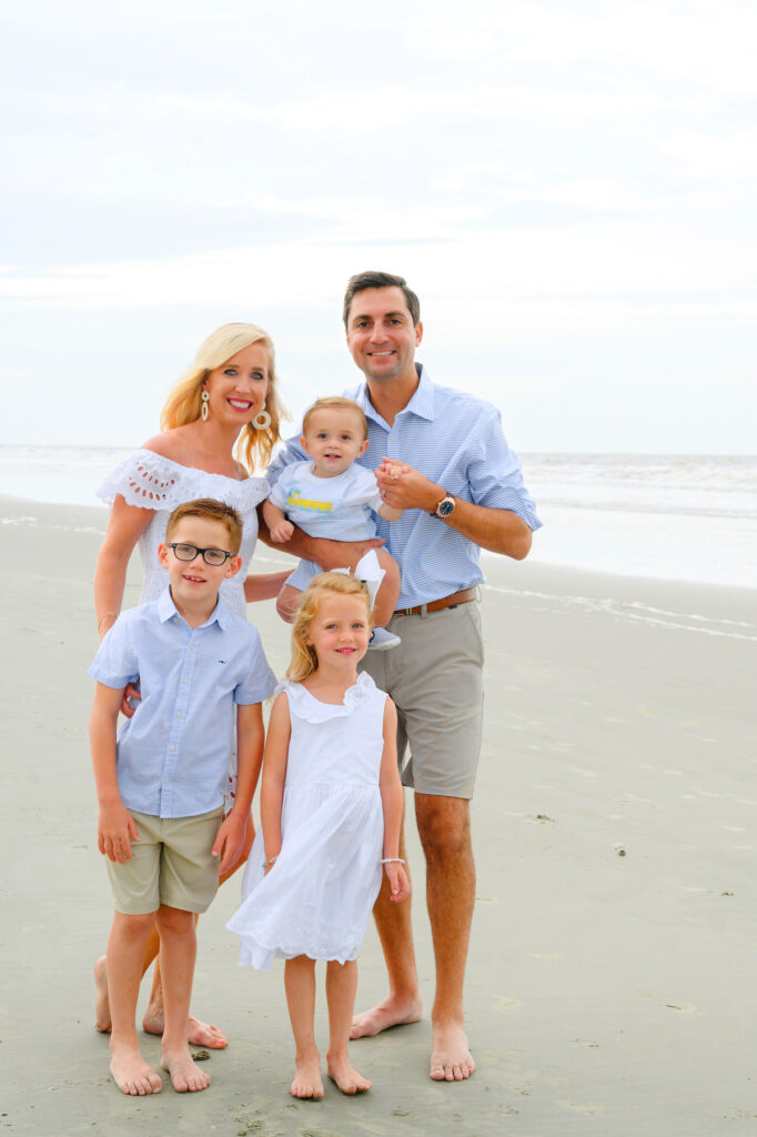 Family with mom, dad, and three children posing Kiawah Beach family photo