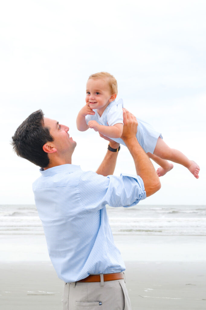 Dad holds son during a Kiawah beach family photo