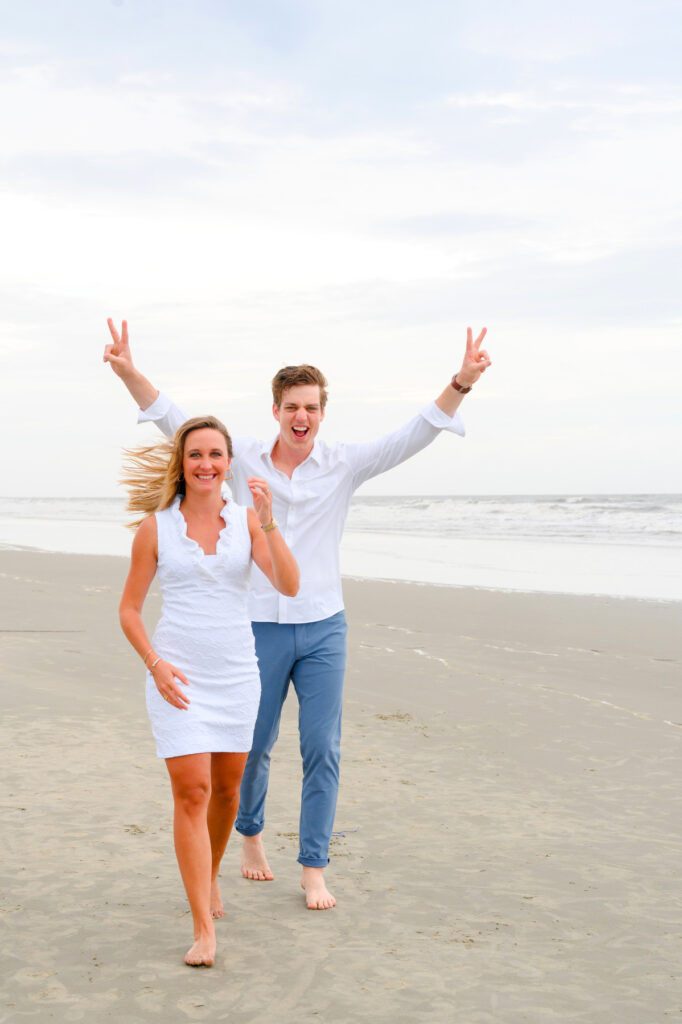 Newlyweds being playful during a Kiawah beach family photo