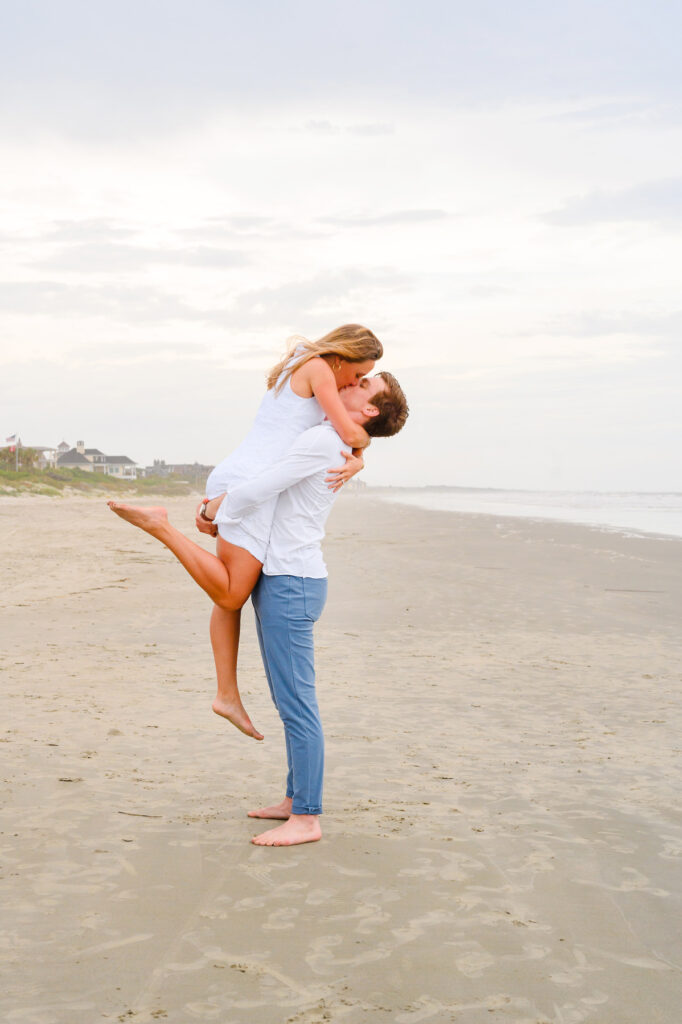 Newlywed couple kiss during a Kiawah beach family photo