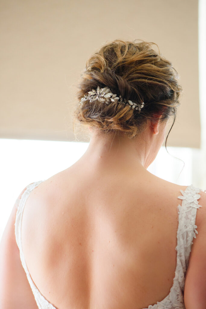 Cedar Room wedding photo of the back of the bride's hairstyle with jeweled hair clip at the St Philip Suite at Planter's Inn Hotel