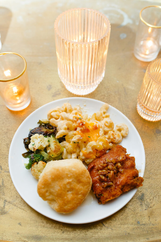 Cedar Room wedding reception with dinner plate of a biscuit, mac and cheese, chicken, and veggies