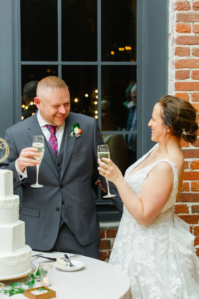 Cedar Room wedding with the bride and groom toasting with each other