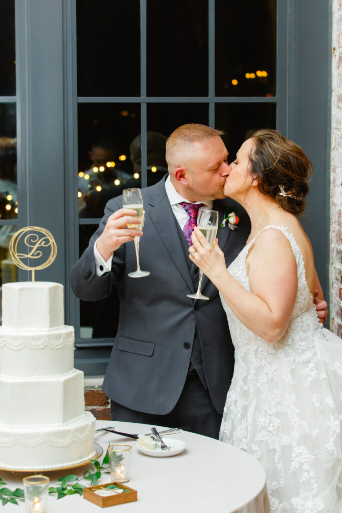 Cedar Room wedding with the bride and groom kissing after a toast