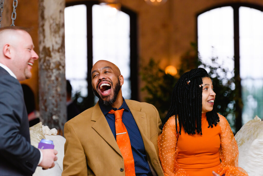 Cedar Room wedding with two guests laughing with the groom at the reception