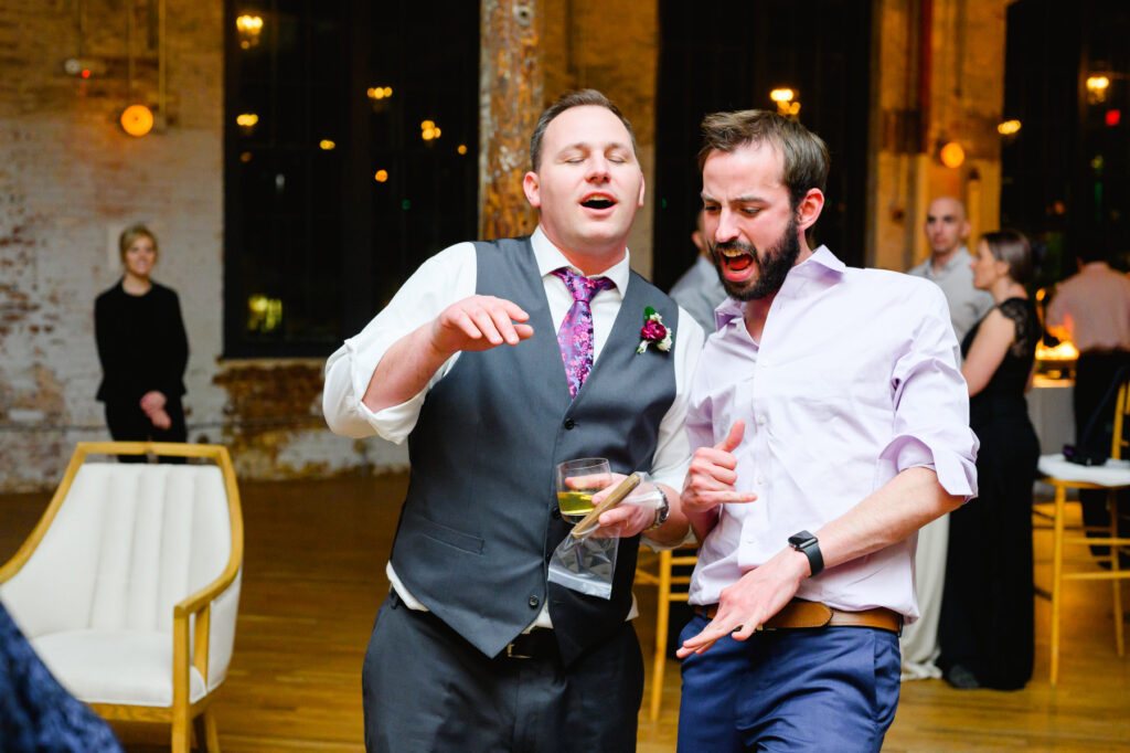 Cedar Room wedding with two male guests dancing at the reception