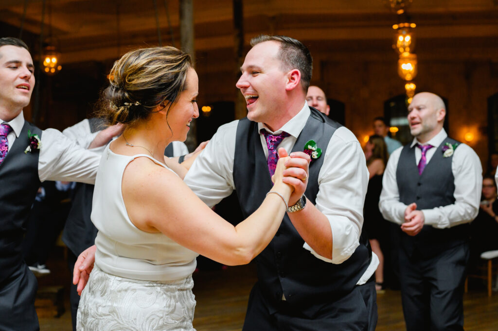 Cedar Room wedding with the bride dancing at the reception with a groomsman