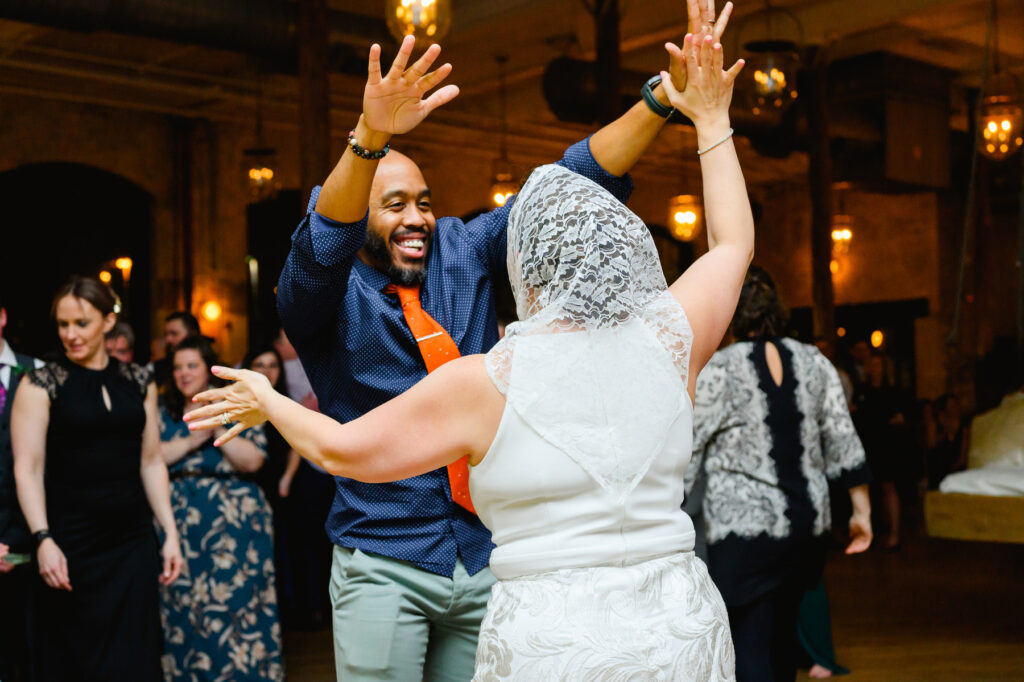 Cedar Room wedding with the bride dancing at reception with a friend for a traditional Polish bride dance