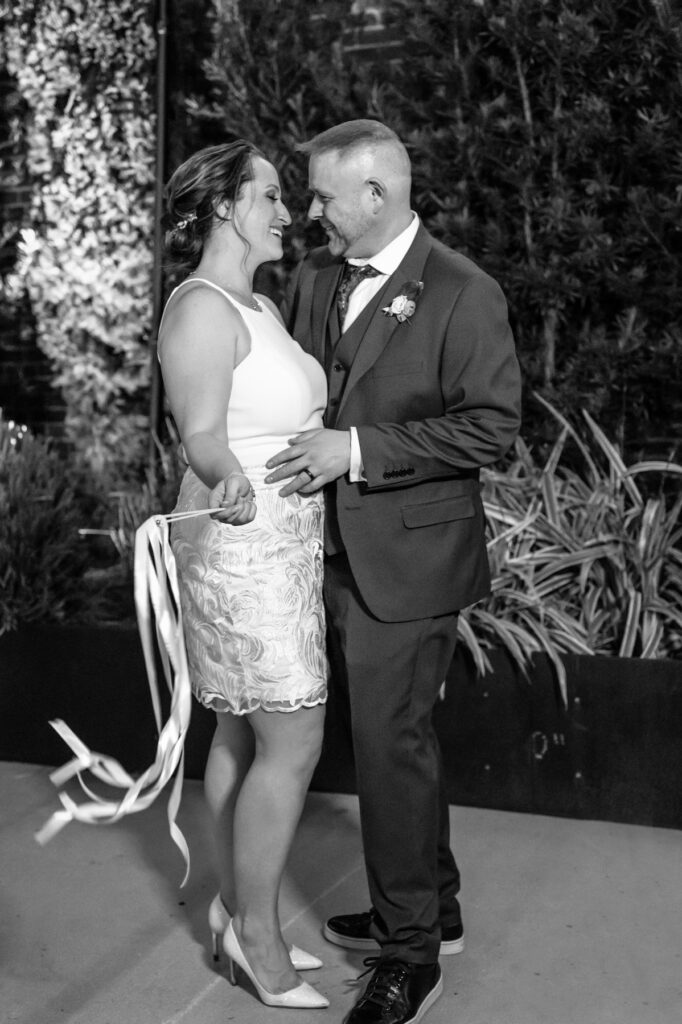 Cedar Room wedding portrait of the newlywed couple in the courtyard at night with streamers