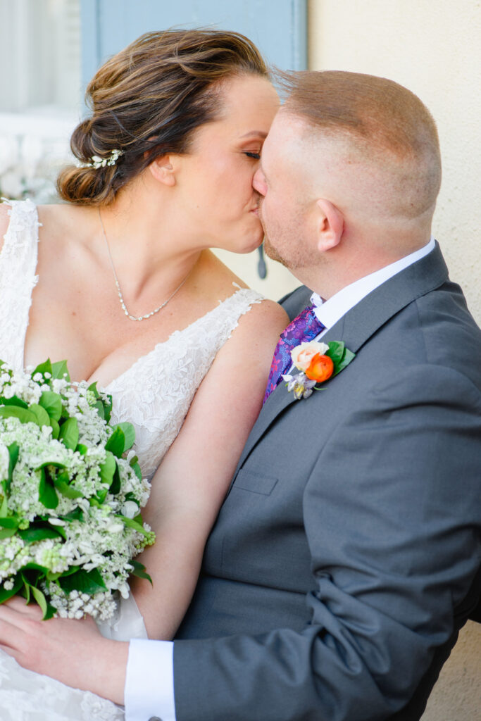 Cedar Room wedding portrait of bride and groom kissing on Rainbow Row