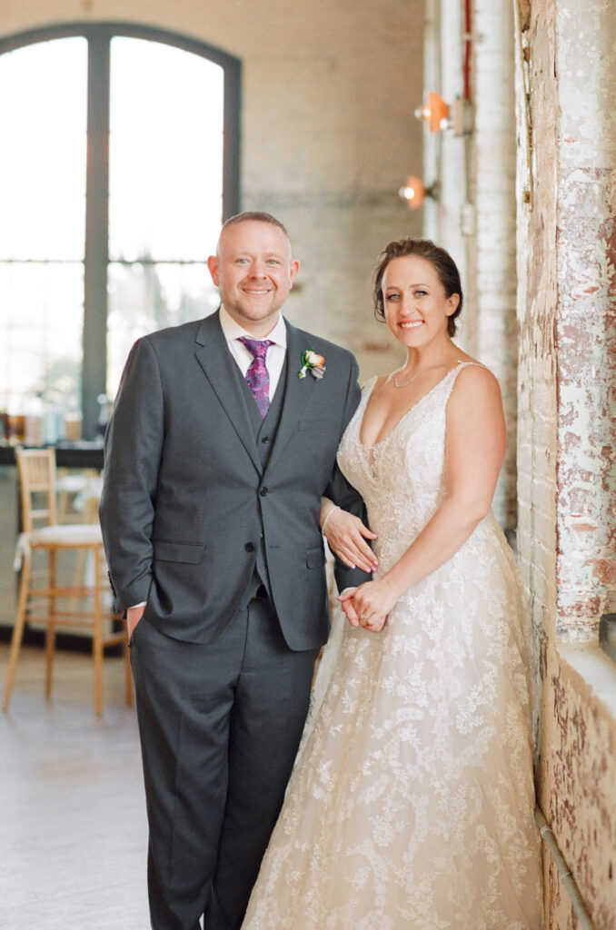 Cedar Room wedding portrait of bride and groom with exposed brick in the background