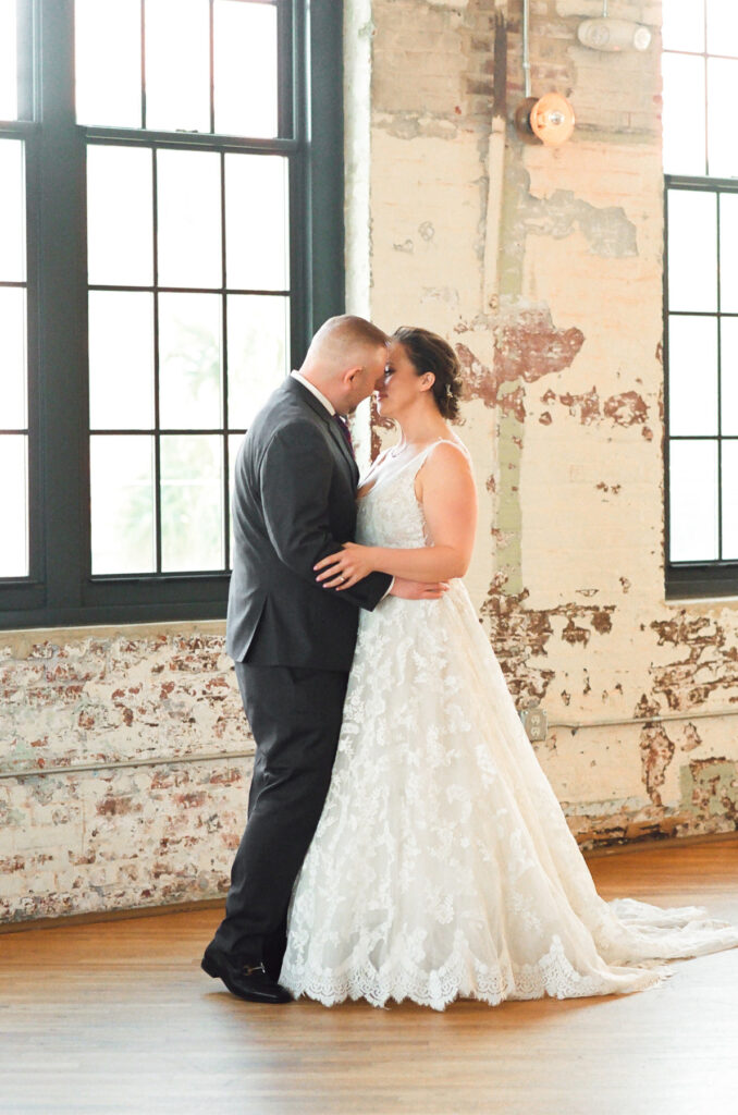 Cedar Room wedding portrait of bride and groom with exposed brick in background